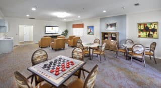 activity with lounge and table/chair seating with spaces for playing games, doing various activities and watching movies or TV together