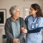 nurse helping older woman